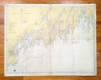 May include: A vintage nautical chart of Monhegan Island to Cape Elizabeth, Maine. The chart is printed on paper and shows the coastline, islands, and waterways of the area. The chart is dated 1943.