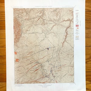 May include: A vintage geological map of the Jonesous area in Colorado, showing topographic features, geological formations, and a legend with symbols and descriptions.
