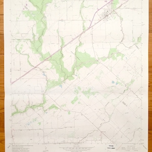 May include: A vintage topographic map of the Louvie, Texas area. The map is printed on white paper with black lines and text. The map shows roads, rivers, and other geographical features. The map is titled "Louvie Quadrangle, Texas" and includes the text "United States Department of the Interior Geological Survey".