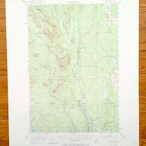 May include: A vintage topographic map of the Stacyville quadrangle in Maine, showing the towns of Stacyville, Patten, and Brownville. The map is printed on a light green background with brown lines and text.