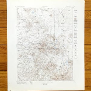 Puede incluir: Un mapa topográfico antiguo de los condados de Shasta y Tehama en California. El mapa presenta líneas de contorno detalladas, nombres de lugares y una leyenda. El papel tiene una apariencia ligeramente envejecida, con una paleta de colores marrón claro y blanco.