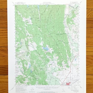 May include: A detailed topographic map of the Mt. Tamalpais area in California, featuring green shaded areas representing forests and blue for water bodies. The map includes contour lines, roads, and place names, printed on white paper.