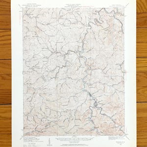 May include: A vintage topographic map of West Virginia, showing contour lines, rivers, and place names. The map is printed on aged paper with a beige and brown colour palette, depicting the state's mountainous terrain. The map includes text from the United States Department of the Interior.
