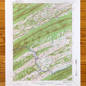 以下が含まれることがあります： ペンシルベニア州ミフリンタウン地域のヴィンテージ地形図。この地図は、山、川、道路など、地域の地理的特徴を示しています。地図は紙に印刷されており、緑と茶色の配色になっています。