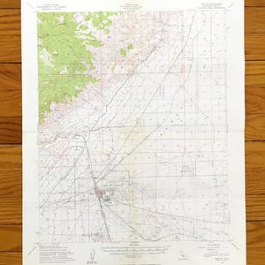 May include: A vintage topographic map with green, brown, and white details. The map features contour lines, roads, and geographical features. The text "UNITED STATES DEPARTMENT OF THE INTERIOR GEOLOGICAL SURVEY" is visible.
