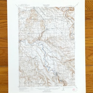 May include: A vintage topographic map of Oregon, featuring detailed contour lines, rivers, and roads. The map is printed on aged paper, with text indicating the United States Department of the Interior, Geological Survey, and the State of Oregon.
