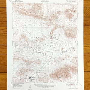 May include: A vintage topographic map of the United States, featuring contour lines and geographical details. The map is printed on aged paper, with text indicating the area as the 'Tiefort Mountains Quadrangle, California'. The map includes the 'Camp Irwin Military Reservation'.