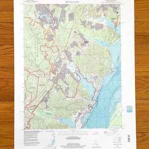 May include: A United States Geological Survey topographic map of the Quantico Quadrangle in Virginia and Maryland. The map features detailed terrain, water bodies, roads, and infrastructure, with text labels including Marine Corps Base Quantico.