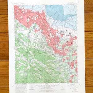 May include: A set of three ceramic mugs with a speckled, matte finish. Each mug features a different color: light blue, cream, and gray. The mugs have a simple, modern design and a comfortable handle.