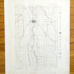May include: A black and white map of a region in North Dakota, Minnesota. The map shows the towns of Fargo, Moorhead, and Glyndon. The map is titled "A Region in Youth" and is dated 1883.