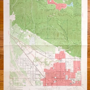 May include: A vintage topographic map of San Bernardino, California, showing the city's layout and surrounding areas. The map is printed in black and white with green and pink accents. The map is titled "San Bernardino North Quadrangle" and includes the text "UNITED STATES DEPARTMENT OF THE INTERIOR GEOLOGICAL SURVEY" and "STATE OF CALIFORNIA DEPARTMENT OF WATER RESOURCES".