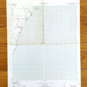 May include: A vintage map of the Texas coastline, featuring detailed topographical information. The map is printed on aged paper and shows the coastal features, roads, and geographical coordinates. The map is folded and has text in the upper and lower corners.