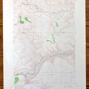 May include: A vintage topographic map of the Eagle Butte Quadrangle, South Dakota. The map shows the area's terrain, rivers, and roads. The map is printed on paper and has a light brown color.