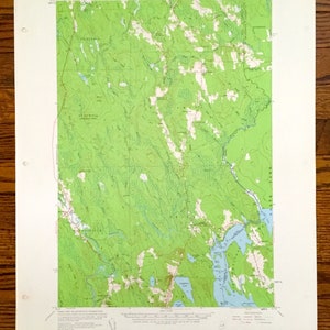 May include: A vintage topographic map of the Pretty Marsh Quadrangle in Maine. The map is printed on paper and shows the area's terrain, rivers, lakes, and roads. The map is dated 1968.
