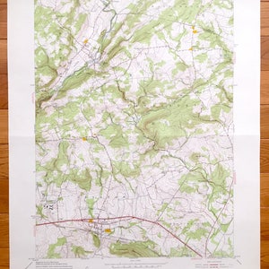 May include: A vintage topographic map of the Califon, New Jersey area. The map shows the terrain, roads, and waterways of the region. The map is printed on paper and has a green and brown colour scheme. The map is titled "Califon, N.J."