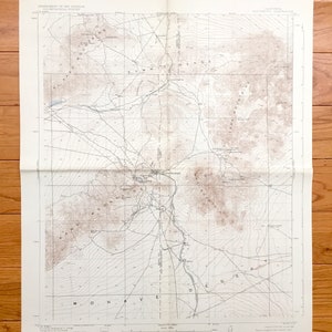 May include: A vintage topographic map of the Mojave Desert in California, USA. The map shows the Summit Range, the Mojave River, and the town of Barstow. The map is printed on paper and has a brown and white color scheme.