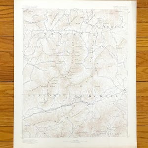 May include: A vintage United States Geological Survey topographic map of the Mount Mitchell region in North Carolina. The map features detailed contour lines in brown ink on a white background, labelling counties like Yancey, Buncombe, and McDowell.