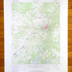 May include: A vintage topographic map of the area around Asheville, North Carolina. The map shows roads, rivers, and other geographical features. The map is printed on white paper and has a green and brown color scheme.