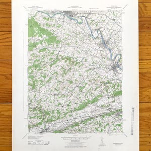 May include: A vintage topographic map of Phoenixville, PA, featuring contour lines, waterways, and forested areas. The map includes the text "Phoenixville Quadrangle" and "Geoscience Department". The map is printed on aged paper.