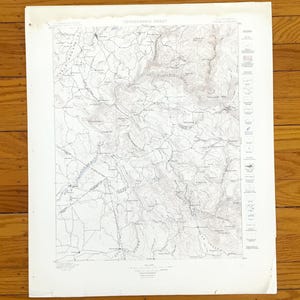 May include: A vintage topographic sheet map of California, featuring detailed contour lines, elevations, and geographical features. The map is printed on aged paper with the title "TOPOGRAPHIC SHEET" at the top. The map is a detailed representation of the terrain.