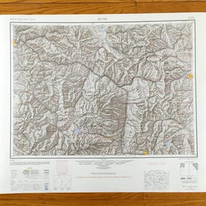 May include: A detailed topographic map of Butte, Montana, showing contour lines, roads, and geographical features. The map is printed on white paper and provides a detailed view of the terrain. The title "BUTTE" is printed at the top.