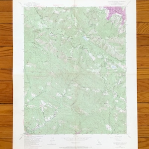 May include: A vintage topographic map of the Castle Rock quadrangle, featuring detailed contour lines and geographical features. The map is printed on aged paper with green and purple hues, showing elevation changes and terrain. The map is a detailed representation of the area.