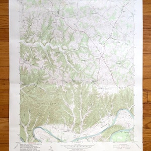May include: A vintage topographic map of the Crestwood, Kentucky area. The map shows roads, rivers, and elevation contours. The map is printed on paper and has a light brown color.