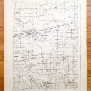 May include: A vintage map of the towns of Amherst, Clarence, Newstead, Lancaster, Alden, West Seneca, Elma, Marilla, East Hamburg, Aurora, and Wales in Erie County, New York. The map is printed on cream-colored paper and shows the roads, rivers, and other geographical features of the area.