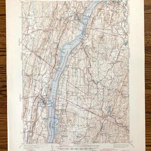 May include: A vintage topographic map of the Hudson River Valley, New York, showing the river winding through the landscape. The map is printed in black and white with blue lines for the river and red lines for roads. The map is dated 1953.