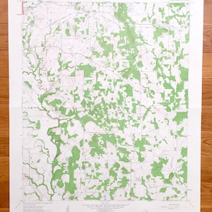 May include: A vintage topographic map of the area around Woodson, Wisconsin, with green areas indicating forested land. The map is titled "Woodson, Wisconsin" and includes the text "GEOGRAPHY DEPARTMENT, MAP LIBRARY, WISCONSIN STATE UNIVERSITY, EAU CLAIRE".