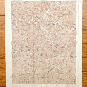 May include: A vintage map of the Glenville, West Virginia area. The map is printed in brown and black ink on a cream-colored paper. The map shows the topography of the area with contour lines and rivers. The map is titled "Glenville, West Virginia" and is dated 1948.
