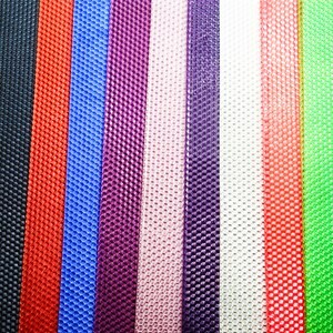 May include: A close-up shot of a variety of colorful, textured ribbons. The ribbons are arranged vertically, showcasing a spectrum of colors including black, red, blue, purple, pink, white, and green. Each ribbon has a distinct honeycomb-like pattern.