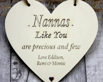 May include: A white wooden heart-shaped sign with the text "Nannas Like You are precious and few. Love Eddison, Remi & Minnie".