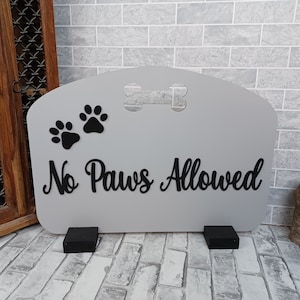 May include: A grey wooden sign with black paw prints and a bone cut-out. The sign reads "No Paws Allowed".
