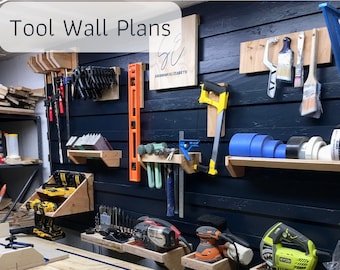 May include: A wall in a workshop with a variety of tools and storage solutions. The wall is painted a dark blue color and has a wooden shelf with a variety of tools, including a saw, a sander, and a drill. There are also several hooks on the wall for hanging tools. The wall is labeled "Tool Wall Plans".