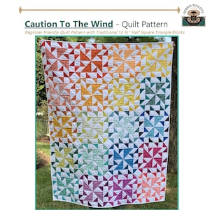 May include: A colorful quilt with a gradient design, transitioning from red to purple, with the text "Caution To The Wind - Quilt Pattern". The quilt is made with half-square triangle blocks. Finished sizes range from 36" x 36" to 108" x 108".