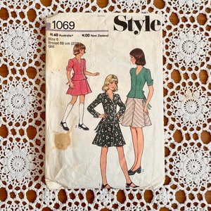 May include: Vintage sewing pattern for a girl's dress. The pattern is for size 8 and has a bust measurement of 27 inches. The pattern is from Style magazine and is numbered 1069.