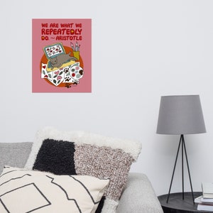 May include: A pink background with a quote from Aristotle: "We are what we repeatedly do."  The quote is illustrated with a cat sitting on a laptop computer with paintbrushes, paint, and hearts surrounding it.