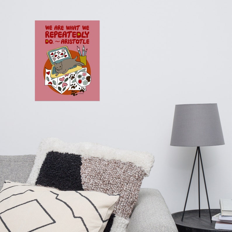 May include: A pink background with a quote from Aristotle: "We are what we repeatedly do."  The quote is illustrated with a cat sitting on a laptop computer with paintbrushes, paint, and hearts surrounding it.
