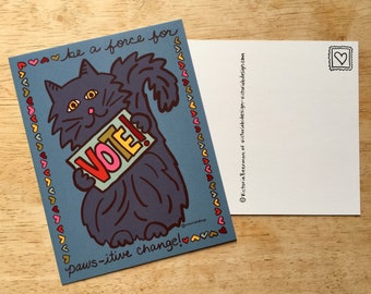 Könnte beinhalten: Eine blaue Postkarte mit einer schwarzen Katze, die ein Schild mit der Aufschrift "VOTE!" hält. Die Katze ist von einem Rand aus rosa, roten, gelben und orangefarbenen Herzen umgeben. Der Text "be a force for paws-itive change!" steht unter der Katze.