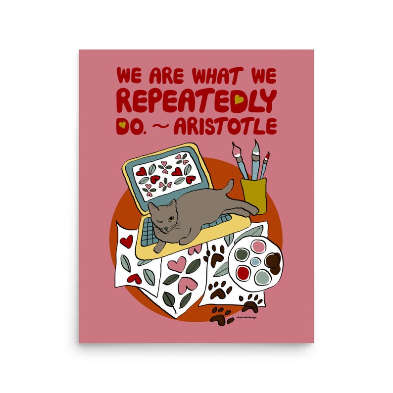 May include: A pink background with a quote in red text that reads "We are what we repeatedly do. ~ Aristotle".  A gray cat is sitting on a laptop computer with a paint palette and paintbrushes on a table.  The laptop screen has a pattern of red hearts on a blue background.