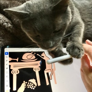May include: A gray cat is looking at a tablet screen with a black and white illustration of a Thanksgiving dinner scene. The cat is holding a white stylus in its paw.