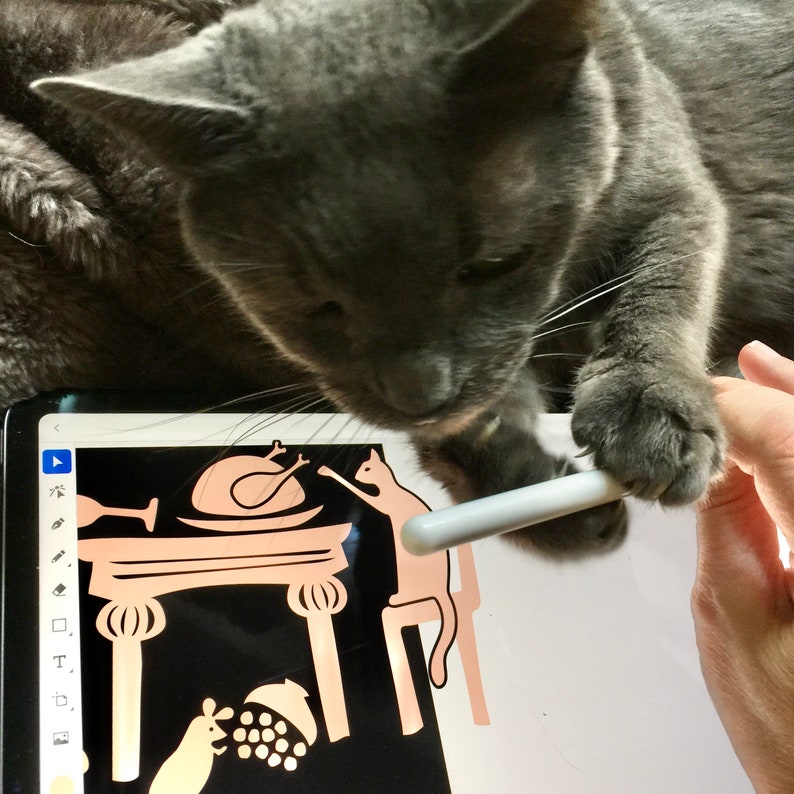 May include: A gray cat is looking at a tablet screen with a black and white illustration of a Thanksgiving dinner scene. The cat is holding a white stylus in its paw.