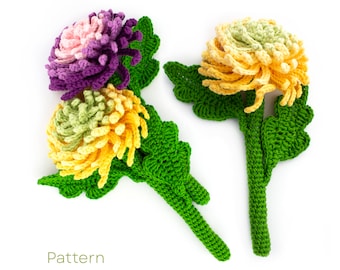 May include: Two crocheted chrysanthemum flowers with green leaves and stems. One flower is purple and pink, the other is yellow and green.