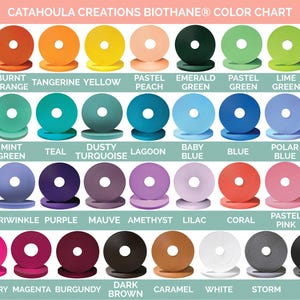May include: Color chart of Biothane® by Catahoula Creations. The chart displays a variety of colors, including red, orange, yellow, green, blue, purple, pink, brown, white, gray, and black. Each color is represented by a circular sample with the color name below.
