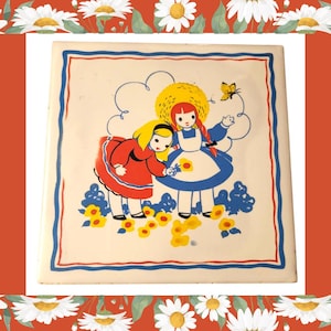 May include: Square ceramic tile featuring a vintage illustration of two girls in dresses and bonnets, surrounded by yellow flowers and a butterfly. The tile has a cream background with a blue and red border.