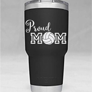 May include: Black and silver stainless steel tumbler with a white vinyl decal that says "Proud MOM" with a volleyball graphic.