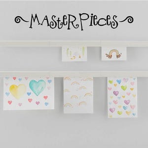 May include: White wall-mounted display shelves holding children's artwork. The artwork includes watercolor hearts, rainbows, and floral designs. The word "MASTERPIECES" is written above the shelves in black script.
