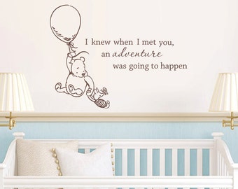 May include: A Winnie the Pooh and Piglet wall decal with a quote that reads "I knew when I met you, an adventure was going to happen".