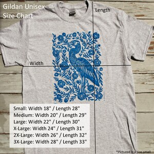 May include: A gray unisex t-shirt with a blue heron and floral print. The size chart shows the width and length measurements for each size: Small (18" x 28"), Medium (20" x 29"), Large (22" x 30"), X-Large (24" x 31"), 2X-Large (26" x 32"), and 3X-Large (28" x 33").